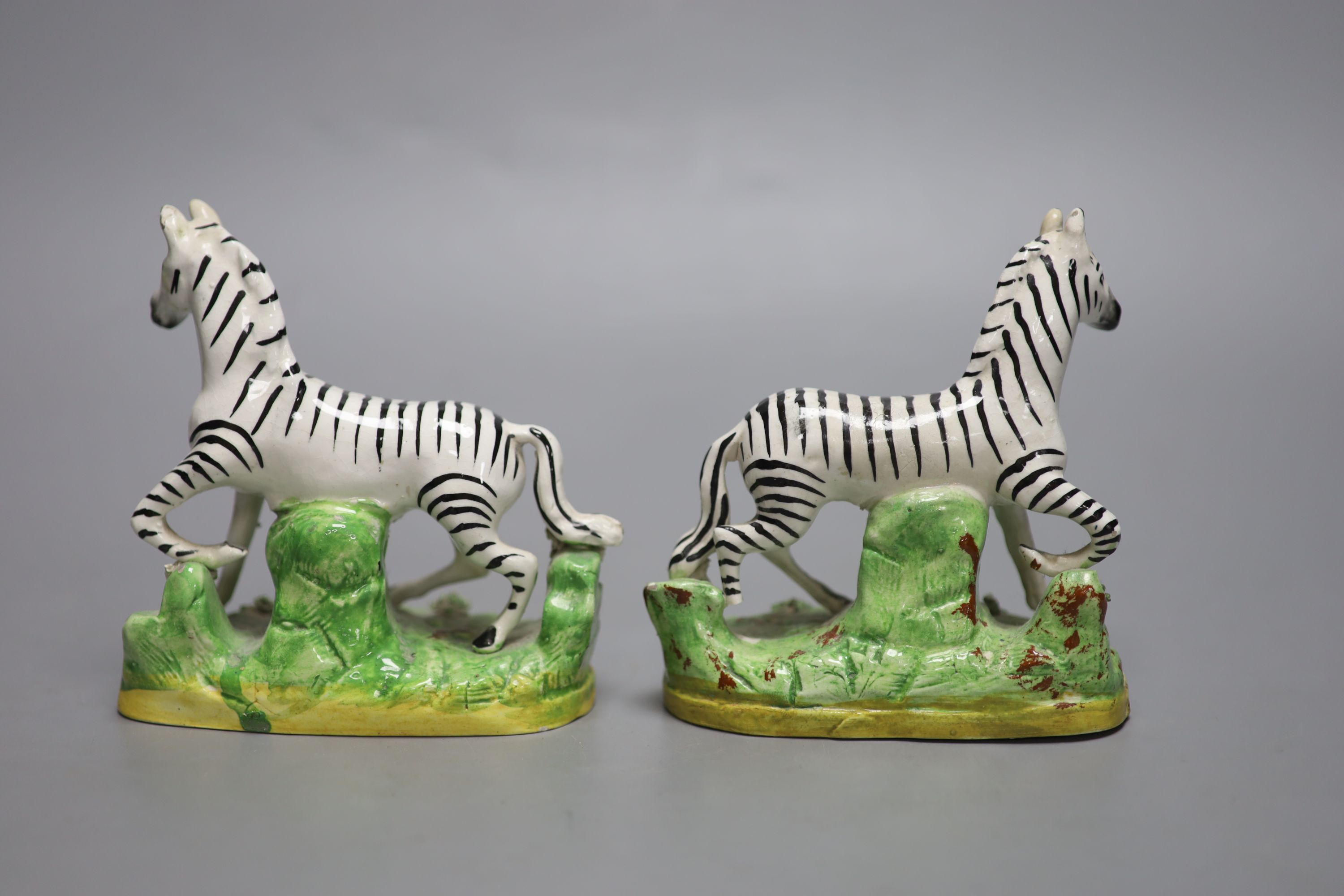 A pair of Staffordshire pottery models of zebra, height 12.5cm